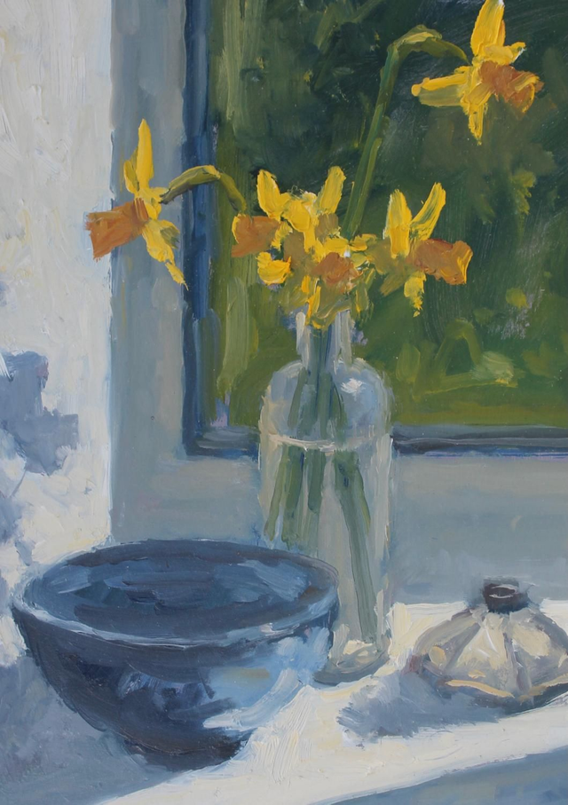 Daffodils in a glass bottle