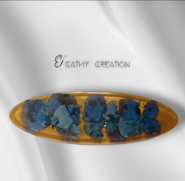 Barrette dorée avec inclusion de fleurs 