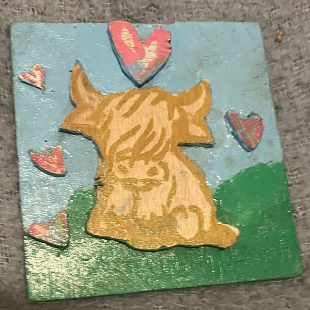Highland cow with hearts around it 18