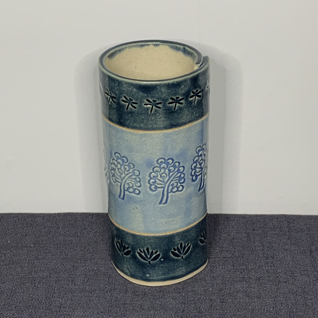 Vase tree, dragonfly and flower head