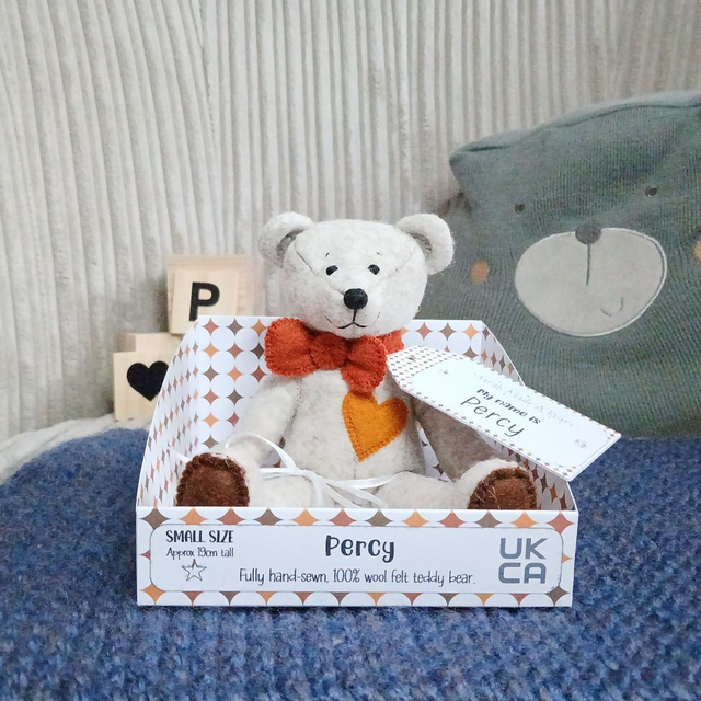Percy. Small size, handmade teddy bear. UKCA. Tray base packaging. Standard Wool Felt. Fluffy beige. Brown. Amber.
