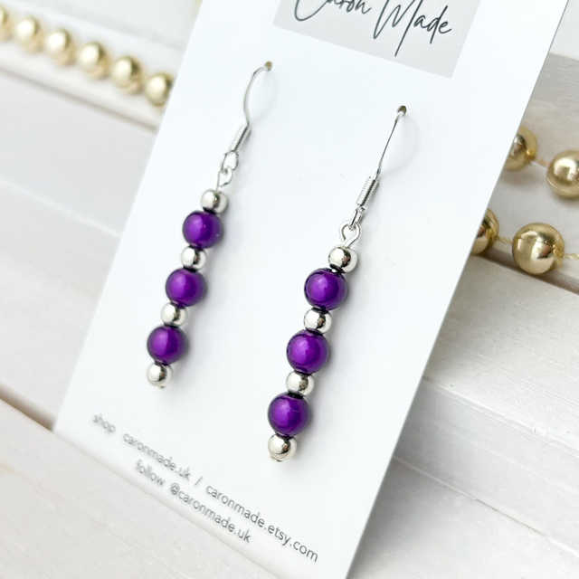 Light reflecting dark purple beaded earrings