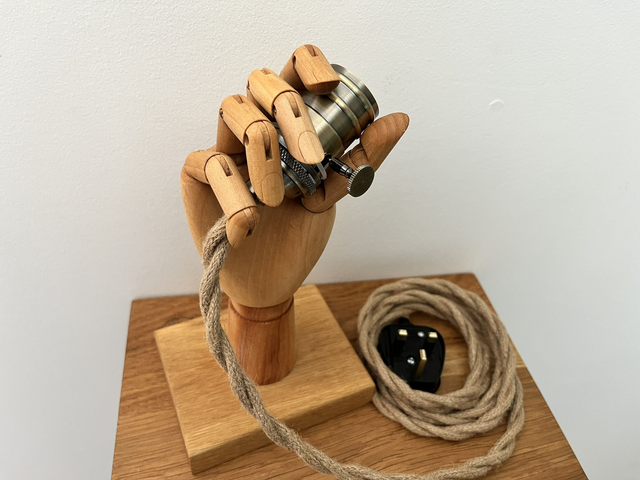 Nice wooden hand holding a light. 