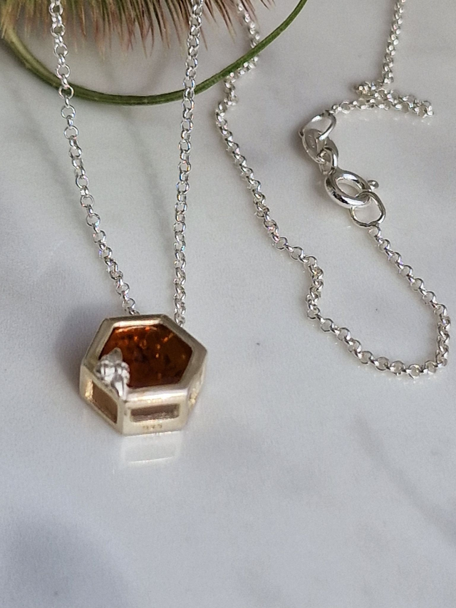 Baltic natural amber honeycomb pendant approx 11x10mm in a honeycomb silver setting with a feature mini bee.18&quot; fine belcher 925 silver chain