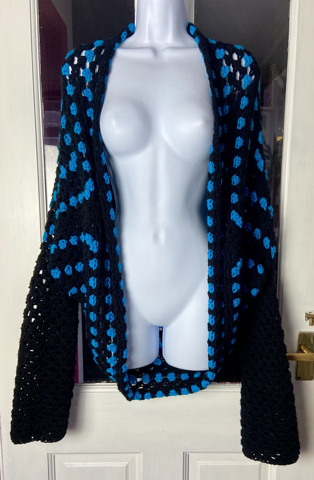 Blue and black shrug style cardigan.