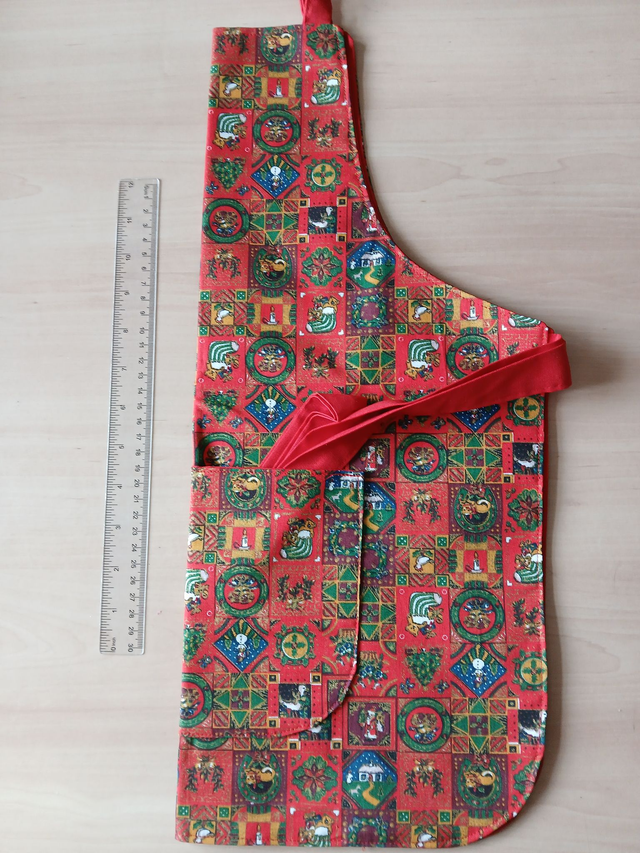 Childs Kitchen Play Apron Festive Patterned Cotton Fabric with Front pocket and Red lining, waist ties and adjustable neck ties