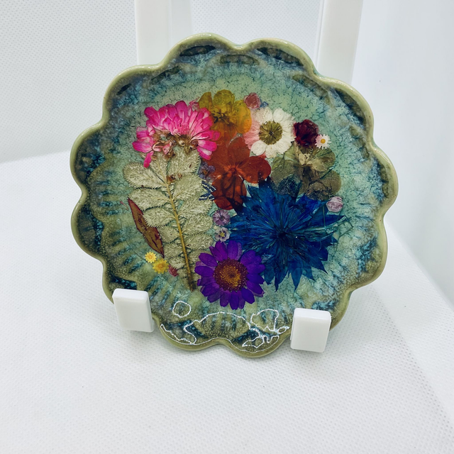 Green ring trinket tray with pressed flowers and resin.