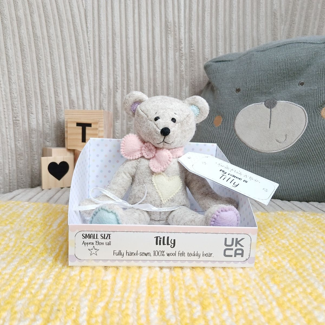 Tilly. Small size, handmade teddy bear. UKCA. Tray base packaging. Standard Wool Felt. Fluffy beige. Pastel yellow, lilac, spearmint and pink.