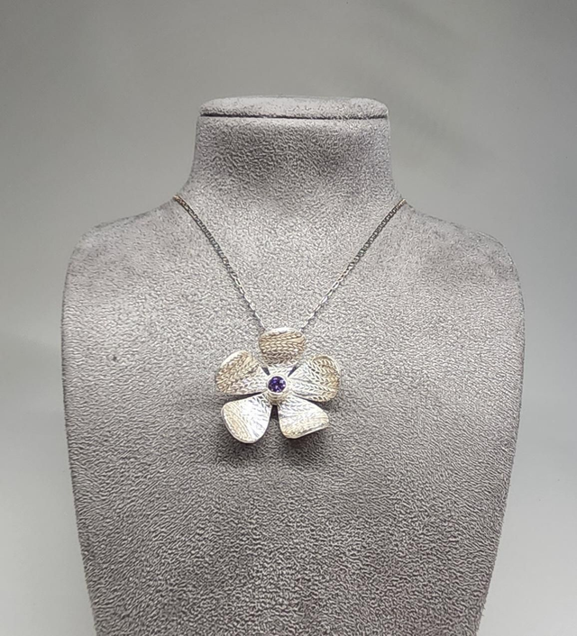 Wheat design textured flower pendant with lilac cubic zirconia on silver necklace