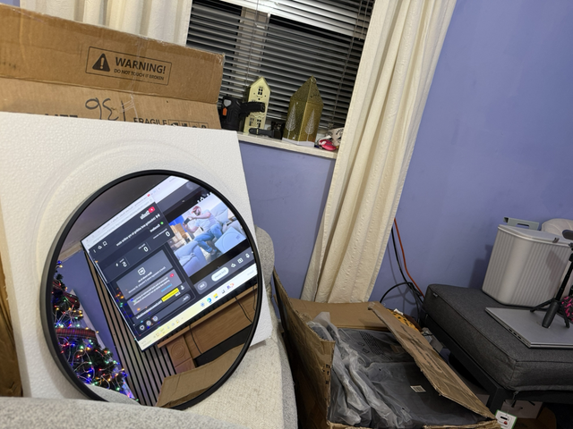 Large circular glass mirror with fixing brackets to the rear