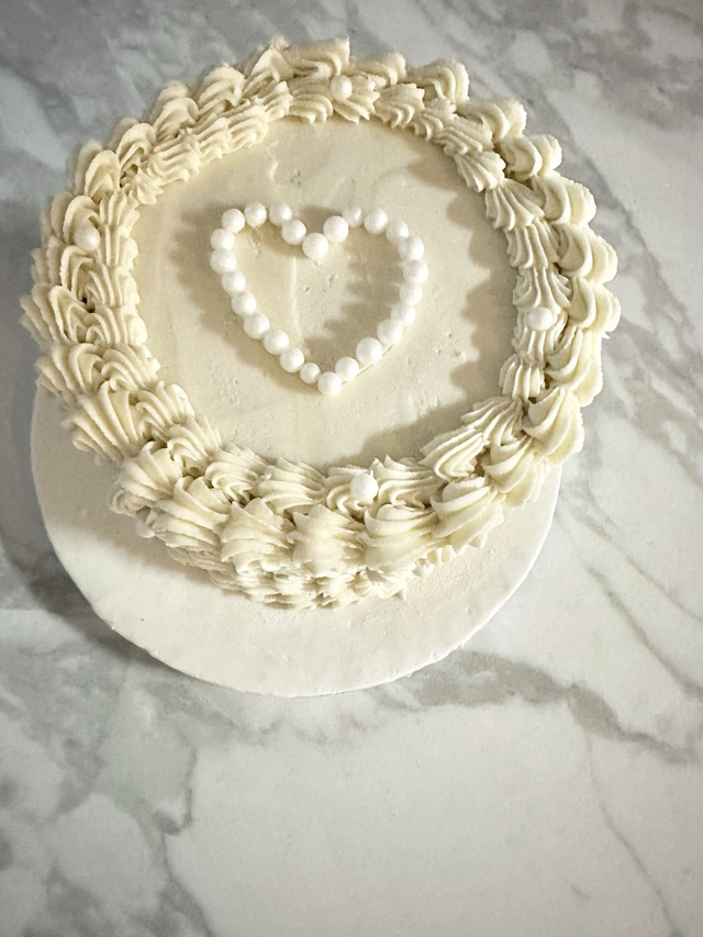 Elegant white Birthday cake decorated with edible pearls