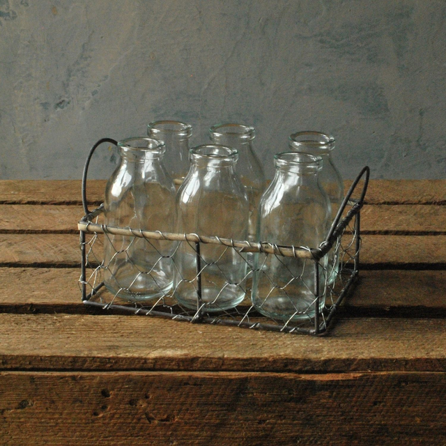 Six Milk Bottles in Wire Basket