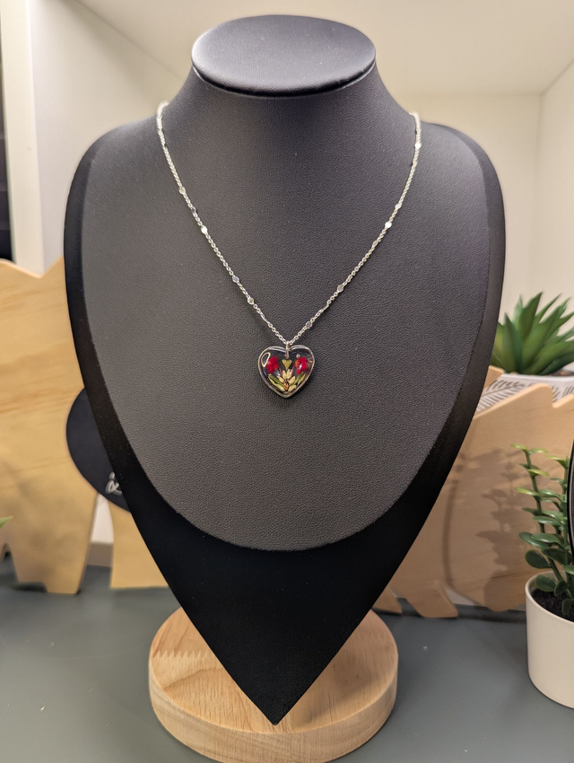 Collier avec une chaine de couleur argent et pendentif en résine en forme de cœur. 