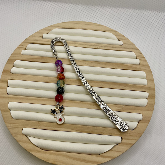Metal bookmark with Christmas beads and charms.