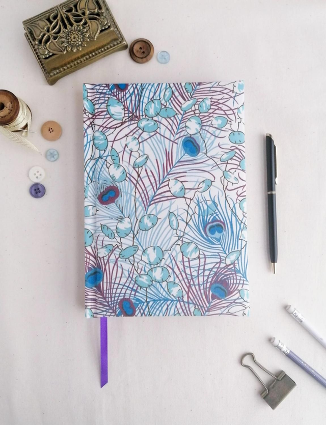 A5 lined notebook with Liberty Honesty peacock fabric cover.