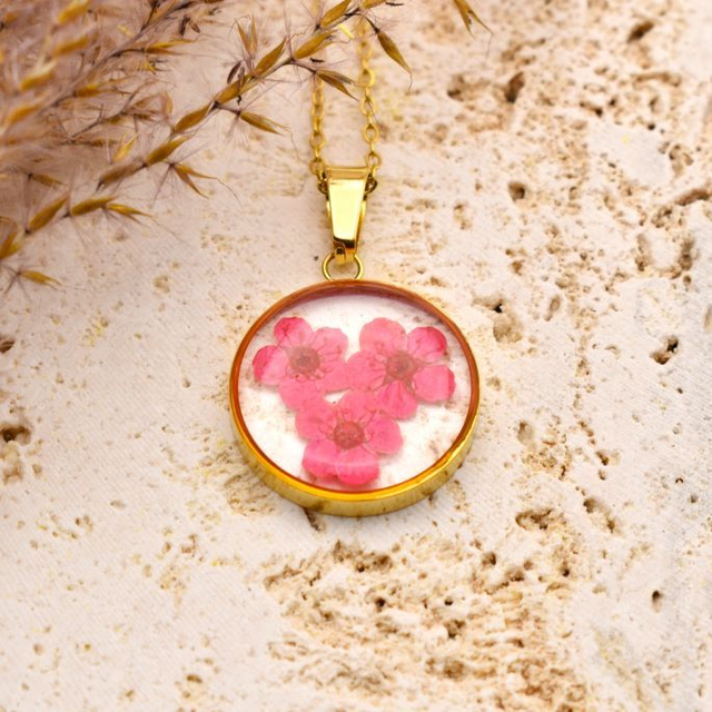 Pink blossom in round pendant