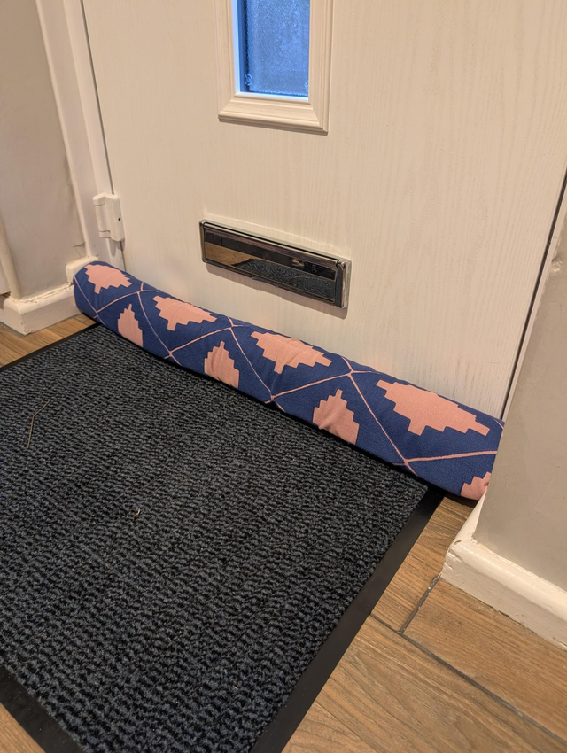Blue and pink geometric draft excluder