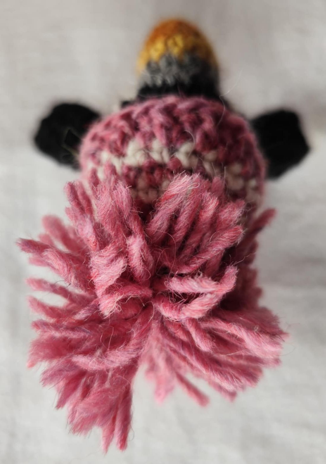 Pixie the puffin wearing pink heather sweater, scarve and hat (made from Icelandic wool yarn)