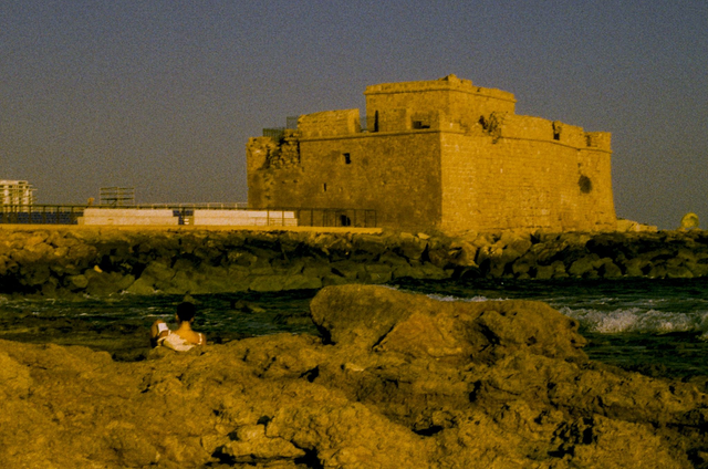 She reads on a Cypriot Shore