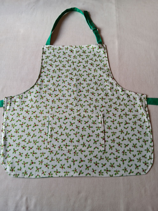 Childs Kitchen Play Apron Cream Holly &amp; Berries Patterned Cotton Fabric with Front pocket and Green lining, waist ties and adjustable neck ties 