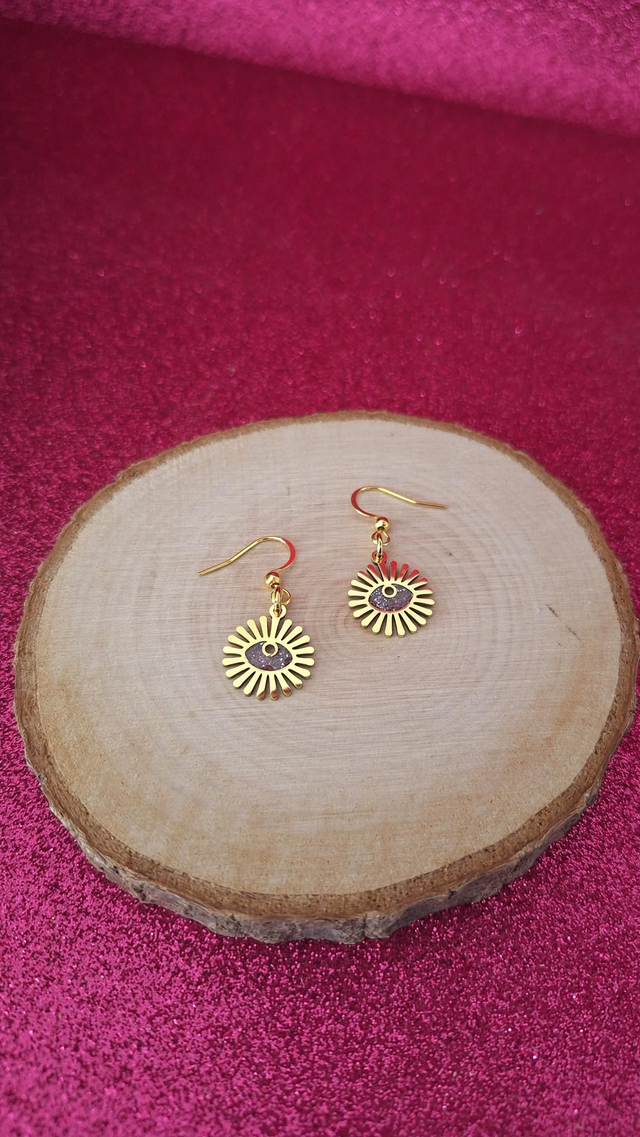 Boucles d&#039;oreilles soleils œils dorés paillettes violettes 