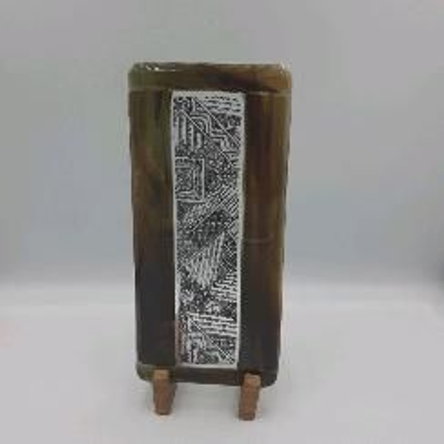 Green patterned  piece in stand 