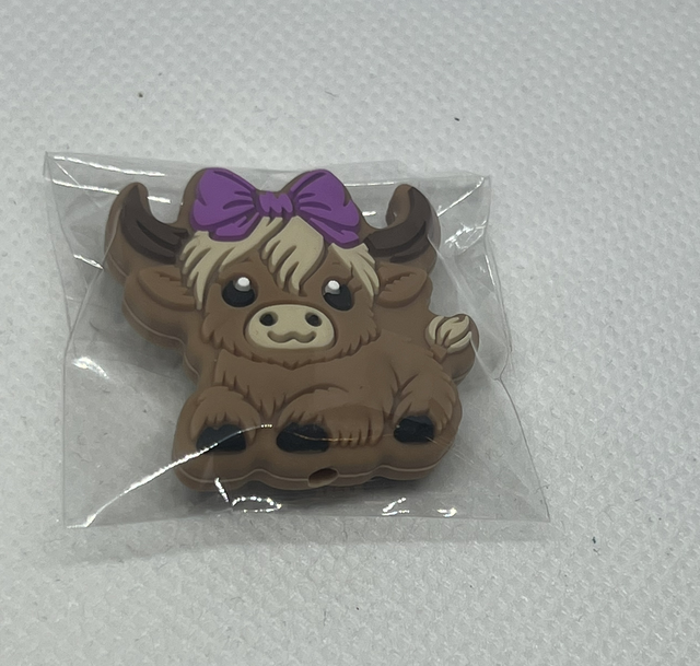 Ku med lilla sløyfe Maskestopper