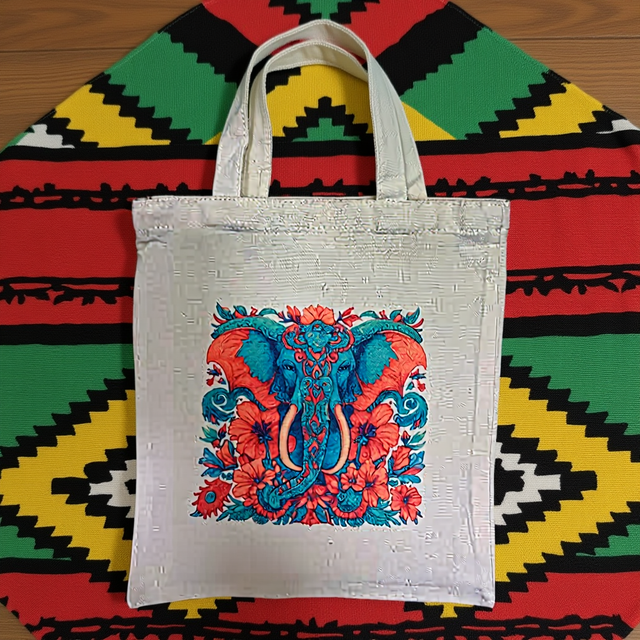A tote bag featuring a colourful elephant in blues and light reds, polyester canvas size H33cm xW29cm medium 