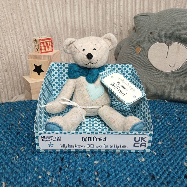 Wilfred. Medium size, handmade teddy bear. UKCA. Tray base packaging. Standard Wool Felt. Beige. Dark teal. Dusky Blue. Spearmint. 