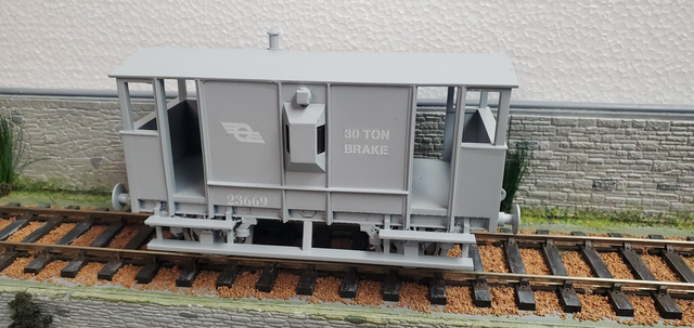 30 ton brake van in flying snail livery.  Fitted with steel wheels running in brass bearings.