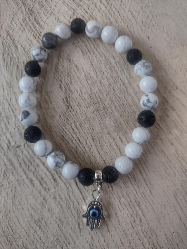 White howlite 8 mm beaded stretch bracelet with black lava beads finished with a Hamza hand charm