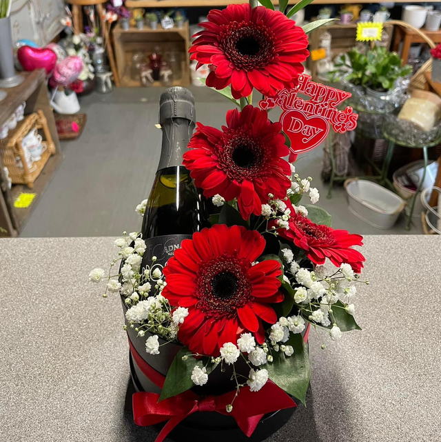 Valentine’s red gerbras and a bottle hat box 