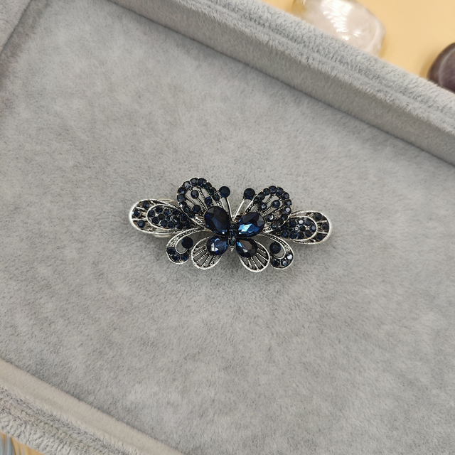 Barrette noire en forme de papillon avec strass bleus - Accessoire élégant et raffiné pour cheveux