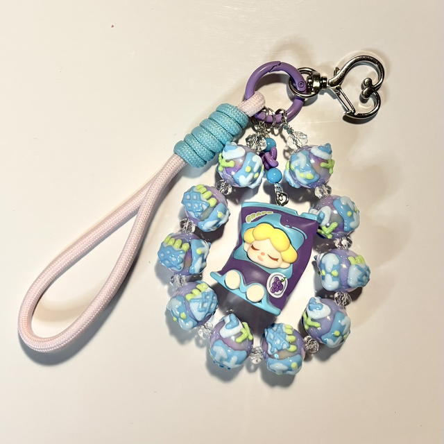 Beautiful handpainted beaded keychain with authentic doll figure in turquoise/purple design