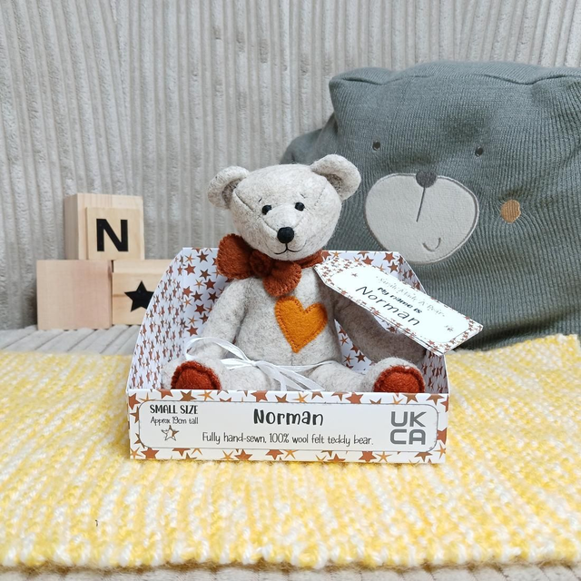 Norman. Small size, handmade teddy bear. UKCA. Tray base packaging. Standard Wool Felt. Beige. Brown. Amber.
