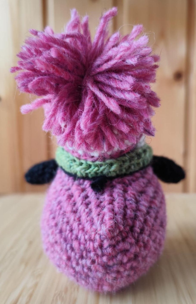 Pixie the puffin wearing pink heather sweater, scarve and hat (made from Icelandic wool yarn)