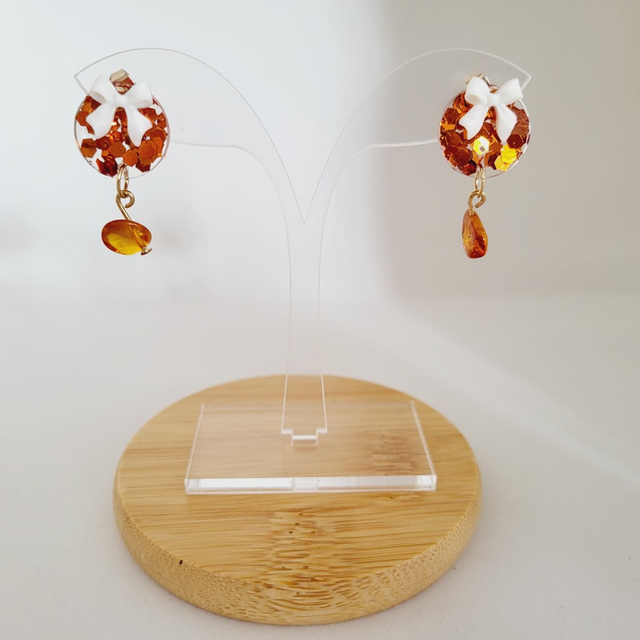 BOUCLE D’OREILLE NOEUD TRANSPARENT AVEC DES PAILETTES BRONZE 