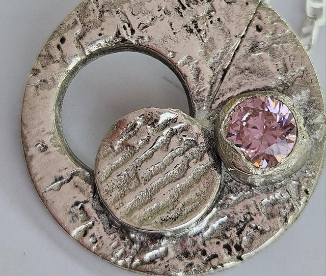 Open circle fine silver pendant with pink cubic zirconia 