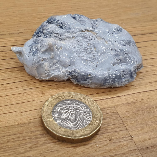 Sleeping silver tabby cat sculpture