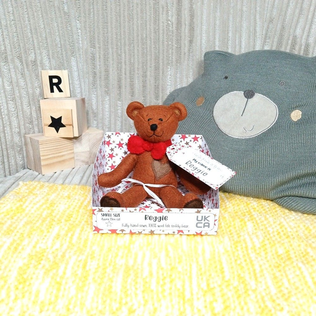 Reggie. Small size, handmade teddy bear. UKCA. Tray base packaging. Standard Wool Felt. Brown. Red.