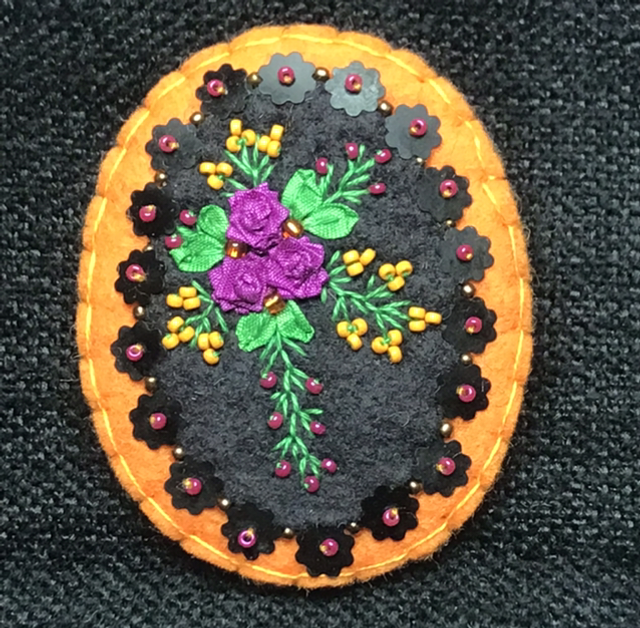Broche Orange/noir/fuchsia ovale