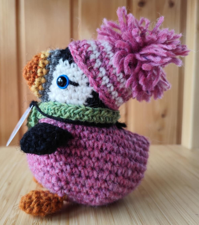 Pixie the puffin wearing pink heather sweater, scarve and hat (made from Icelandic wool yarn)