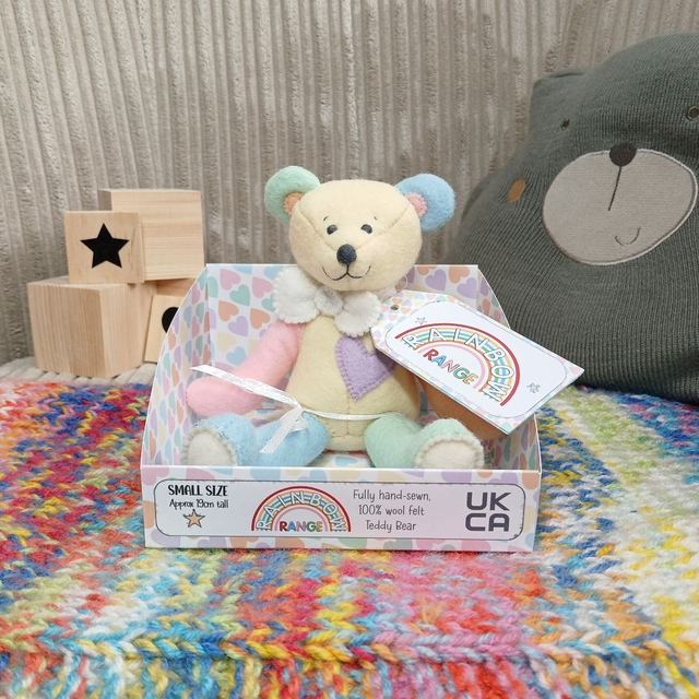 Rainbow, with pastel shades. Small size, handmade teddy bear. UKCA. Standard Wool Felt. Yellow. Orange. Pink. Blue. Purple. Green. White.