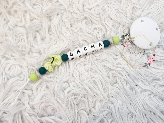 Attache-tétine dino