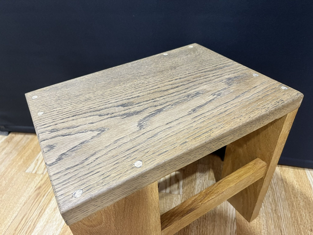 Oak cantilever stool made of solid oak wood in two colors.