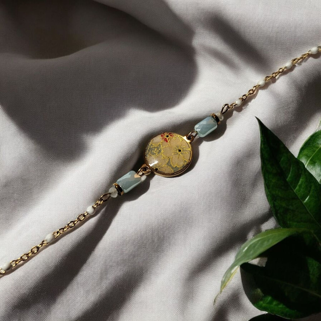 bracelet acier inoxydable motifs japonais blanc beige bleu clair et doré