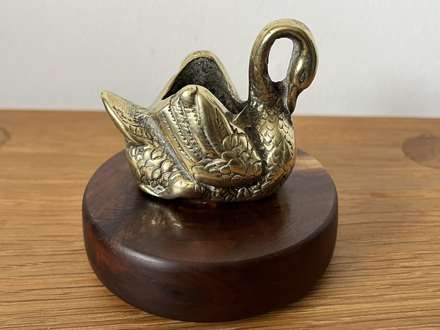 Mid 20th century brass swan on a precious australian muga wood base.