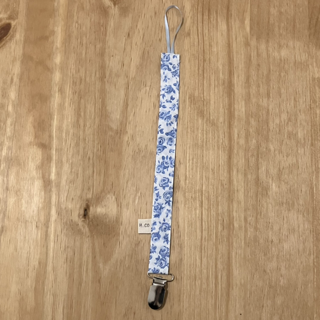 Attache sucette fleur bleu