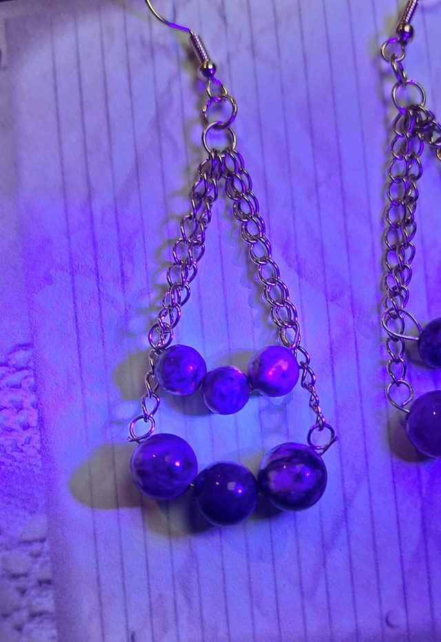 Leto's cradles in gold with AA grade yooperlite and red tourmaline, two earrings