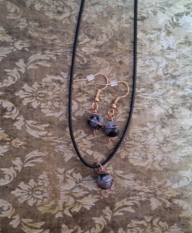 Planetary lovers set in bronze with snowflake obsidian